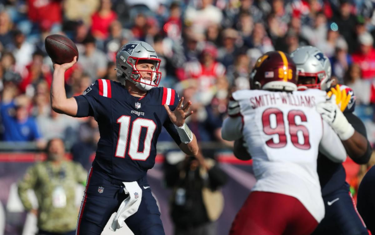 New England Patriots quarterback Mac Jones (10) passes the ball during the first half against the Washington Commanders at Gillette Stadium.